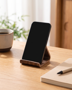 Hameln phone stand holding a phone on an oak desk