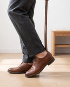 Putting on a leather shoe with the Herford shoe horn