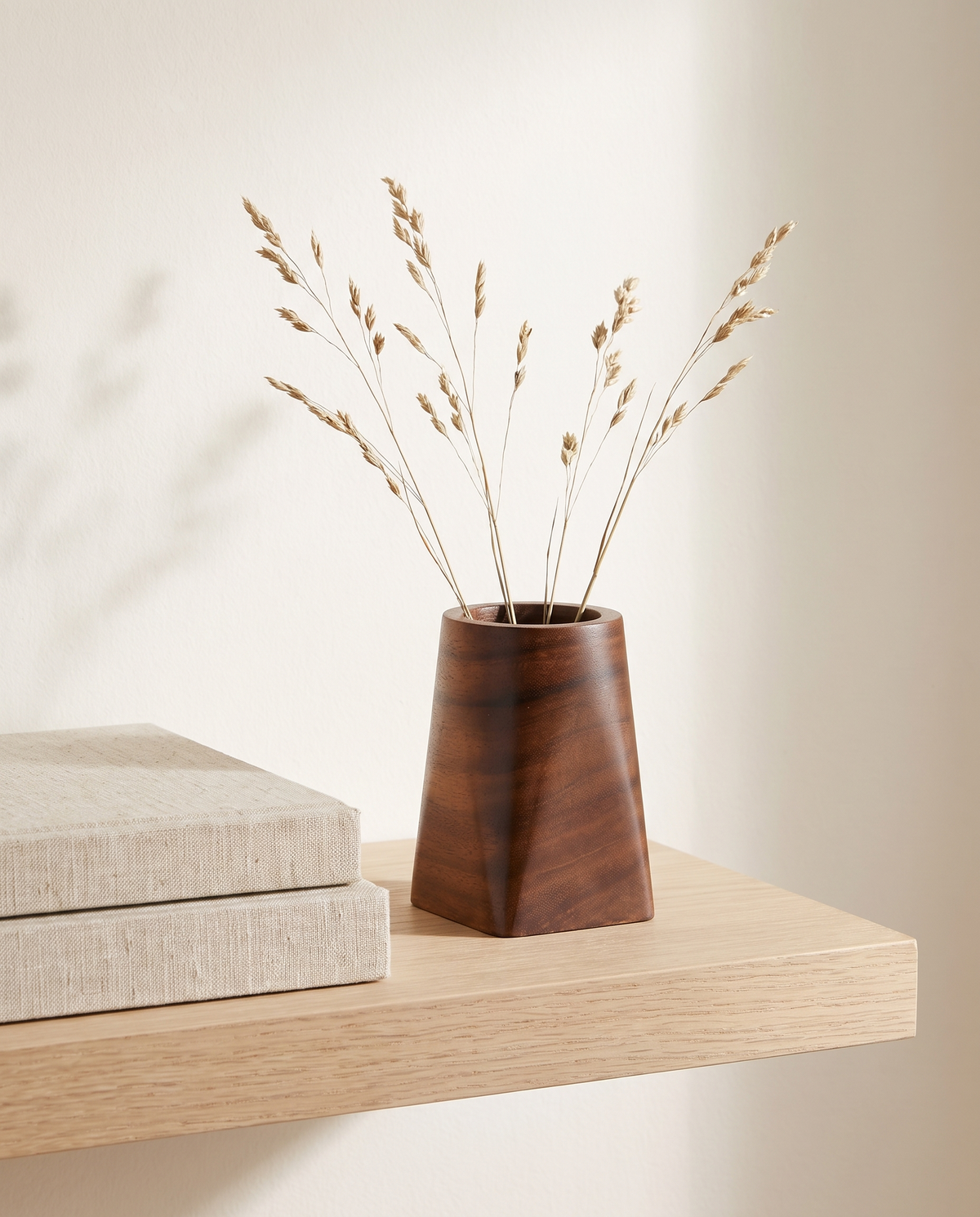 Rostock round walnut pot with dried stems on a shelf