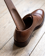 Herford shoe horn guiding a heel into a leather shoe