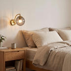 Vimmerby smoke grey wall light beside a bed