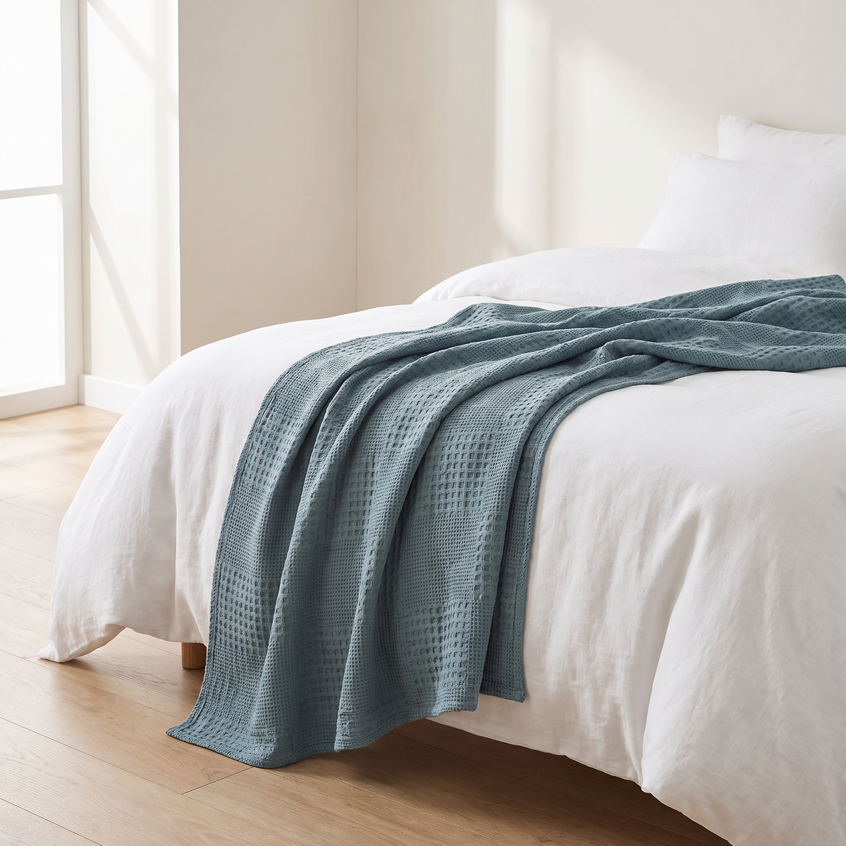 Ostersund lake blue throw on a bed
