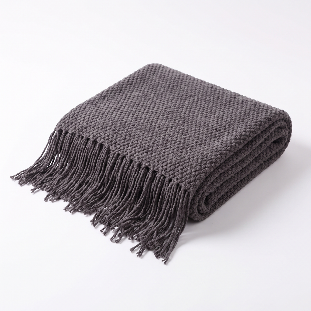 Uelzen knitted tassel throw in charcoal