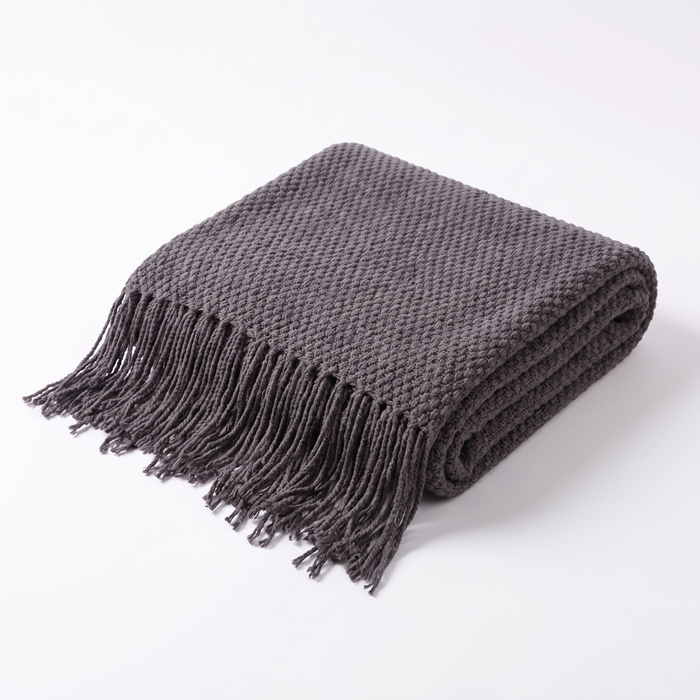 Uelzen knitted tassel throw in charcoal