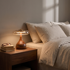 Assens lamp lit on a side table