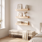 Nakskov shelves stacked above a bench with prints
