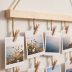 Close up of wooden pegs holding photos on the Lokken