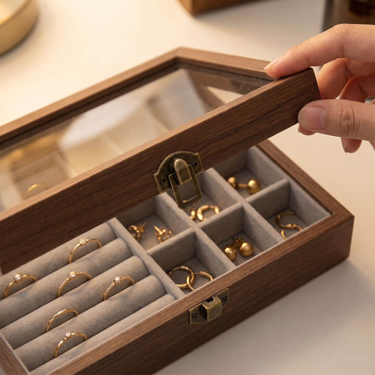 Opening the glass lid of the Bastad jewellery box