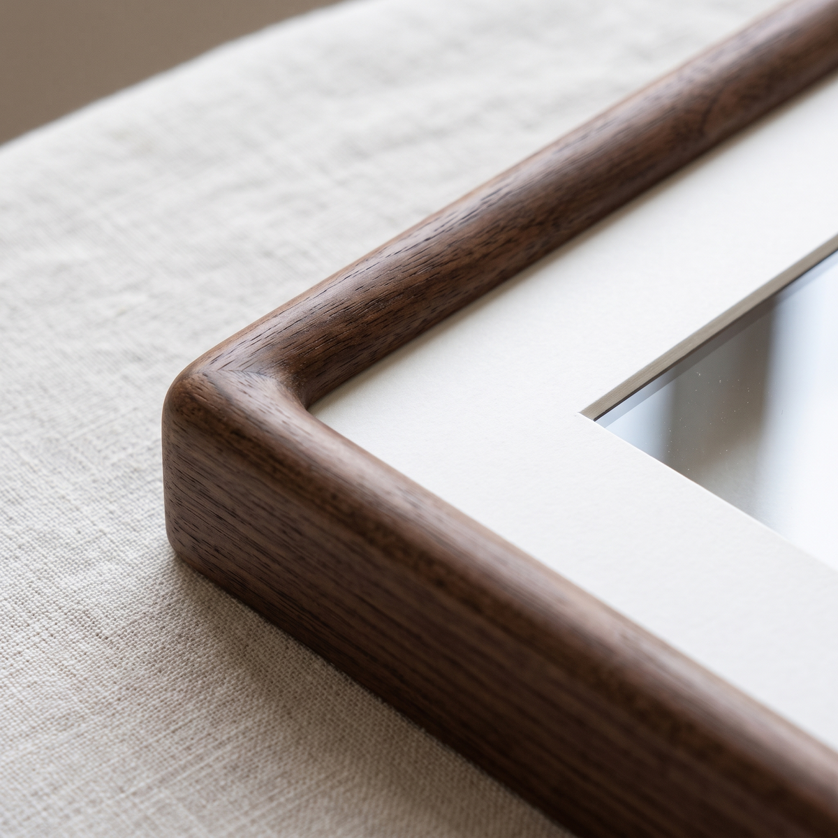 Corner detail of the walnut Ebeltoft frame and mount