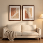 Two walnut Ebeltoft frames above a cream sofa