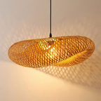 Bogense bamboo pendant casting lattice shadows on a wall