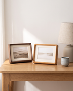 Greifswald frames in walnut and teak tone on a desk