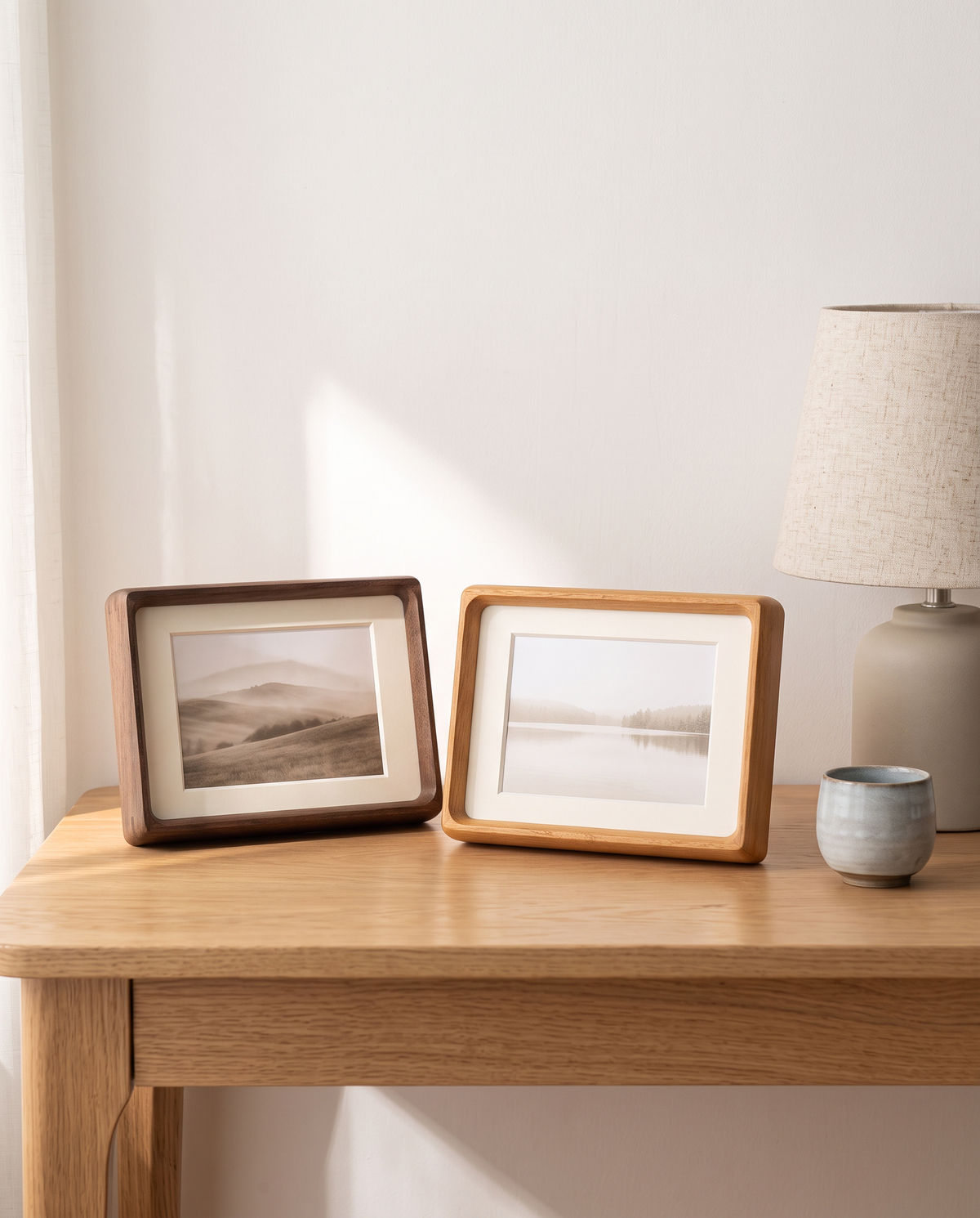 Greifswald frames in walnut and teak tone on a desk