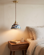 Rosenheim blue floral pendant beside a bed