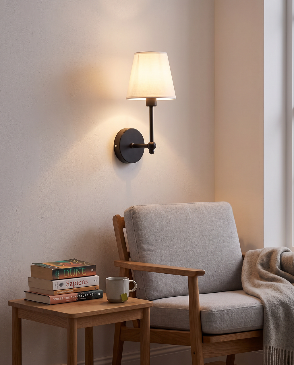 Black Kungalv wall light above a reading chair