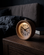 Jever alarm clock on a bedside table at night