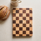 Eslov checkerboard chopping board on a stone worktop beside a sourdough loaf