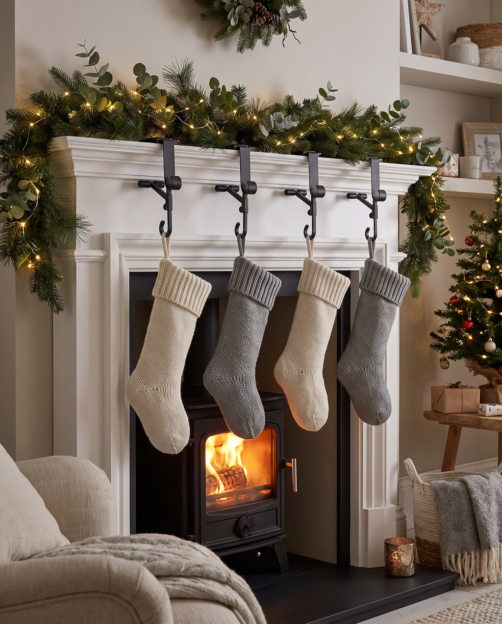 Esens hangers holding a garland and four knitted stockings on a white mantel