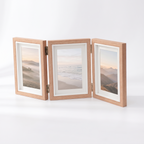 Hildesheim folding triple photo frame in natural wood on a white background