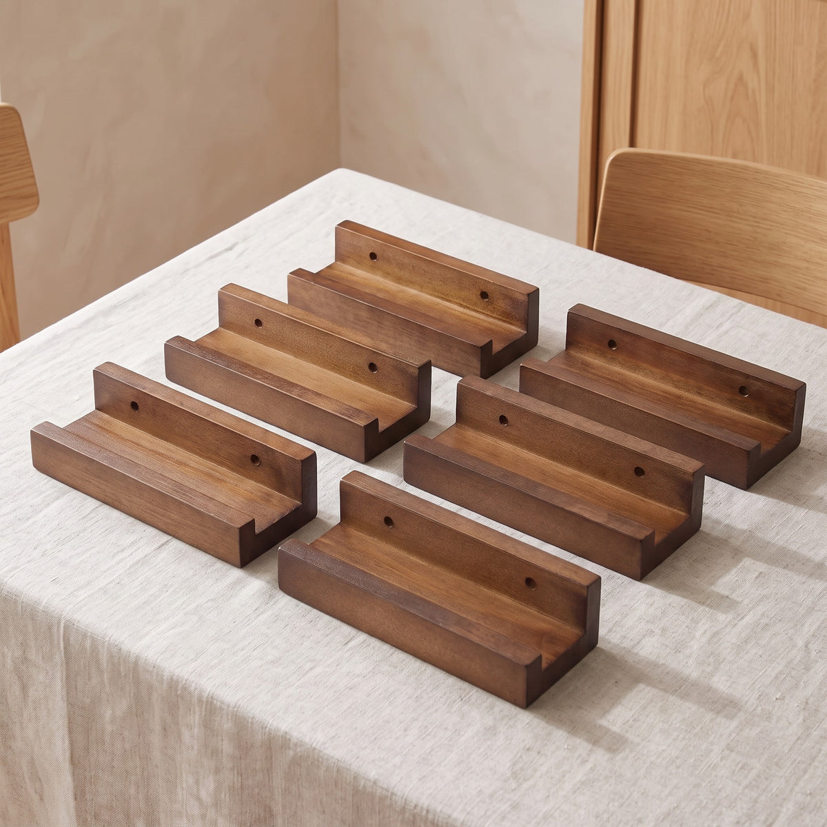 All six Husavik walnut tone record ledges laid out on linen
