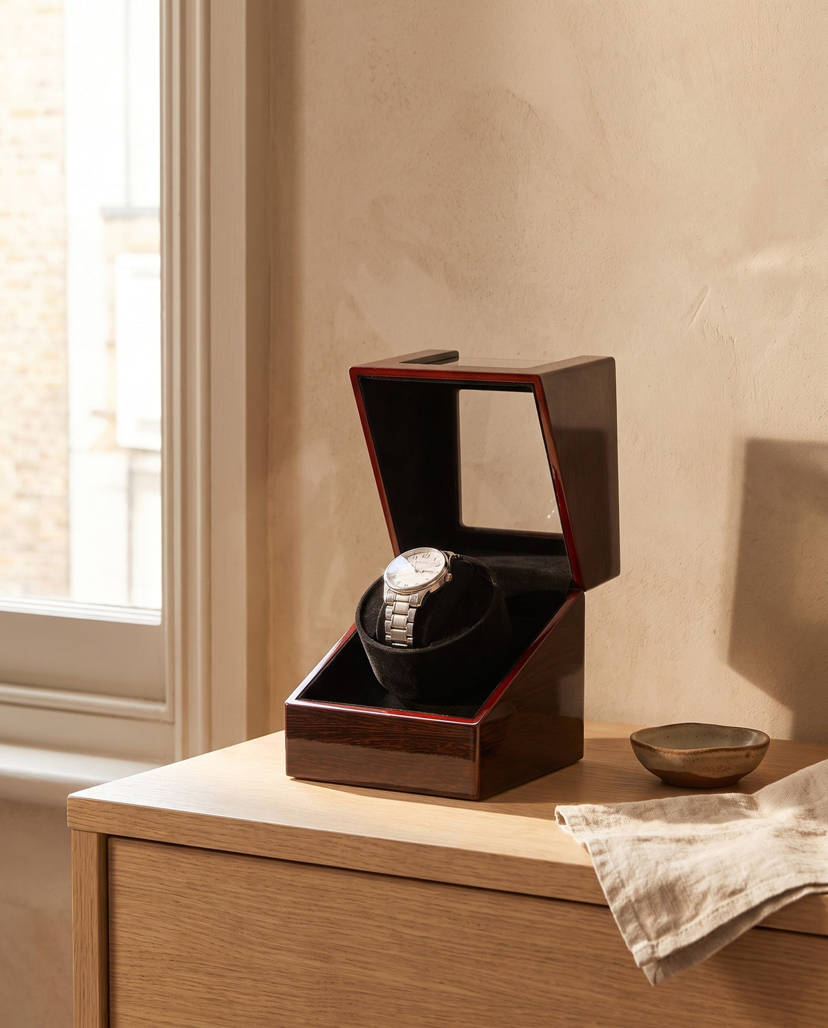 Lahr watch winder with the lid open on an oak dressing table