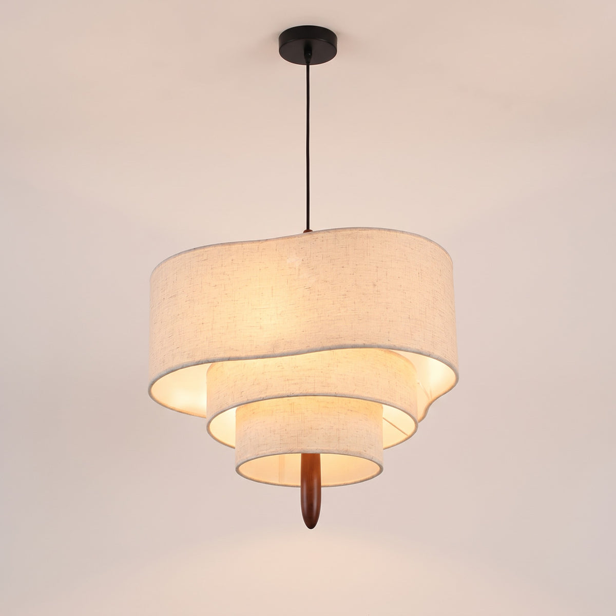 Lauenburg tiered linen look drum chandelier lit, on a light studio background