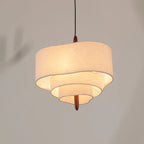 Lauenburg tiered fabric chandelier lit, product photo showing the waved tiers and wood finial