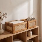 Two Leiden storage crates on a light oak shelf holding linen