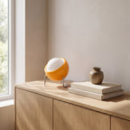 Lugano orange globe table lamp on an oak sideboard