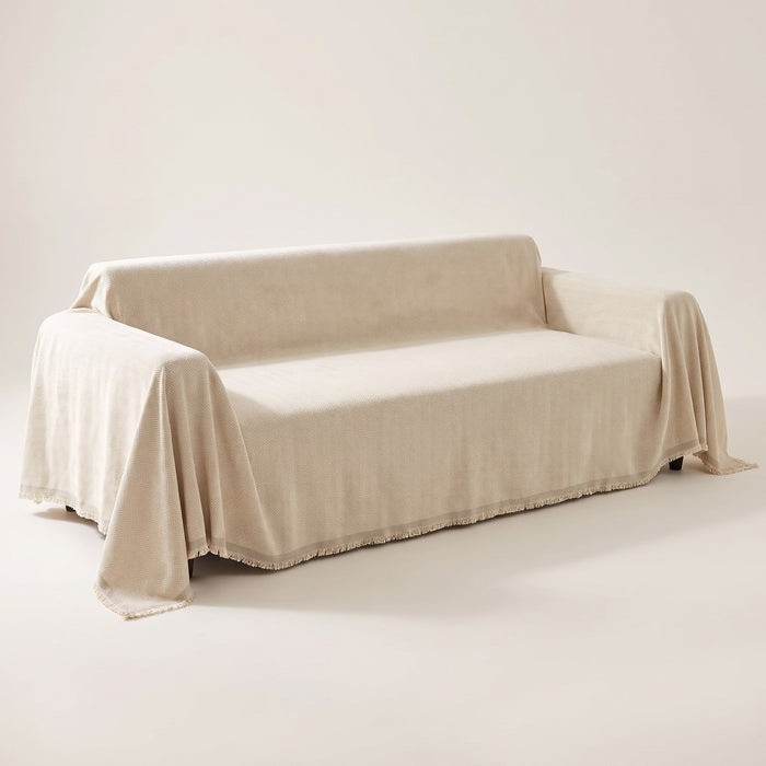 Mariefred herringbone chenille sofa throw in Oat draped over a sofa