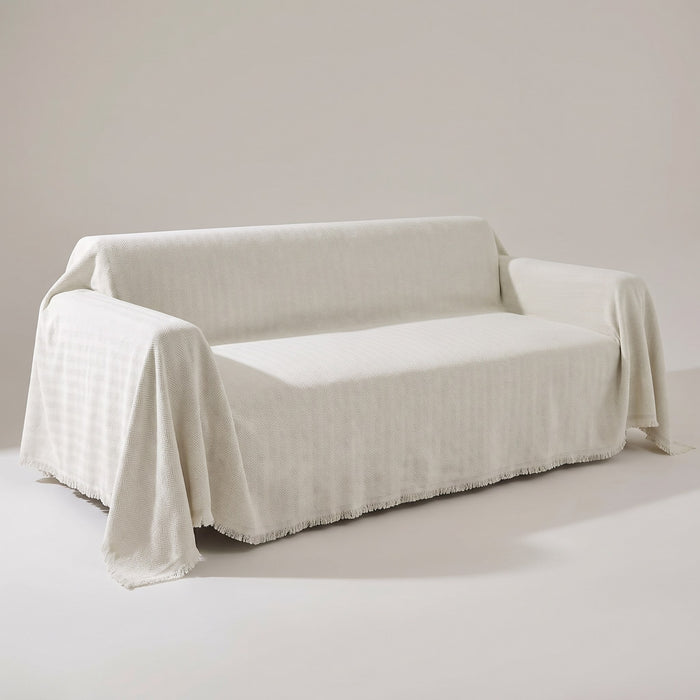 Mariefred herringbone chenille sofa throw in Cream draped over a sofa