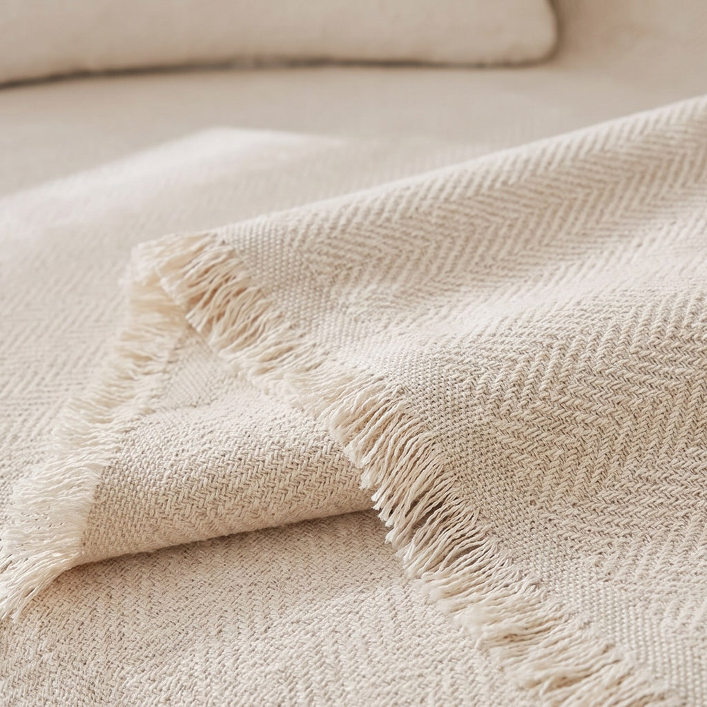 Mariefred sofa throw herringbone chenille weave and frayed fringe close up