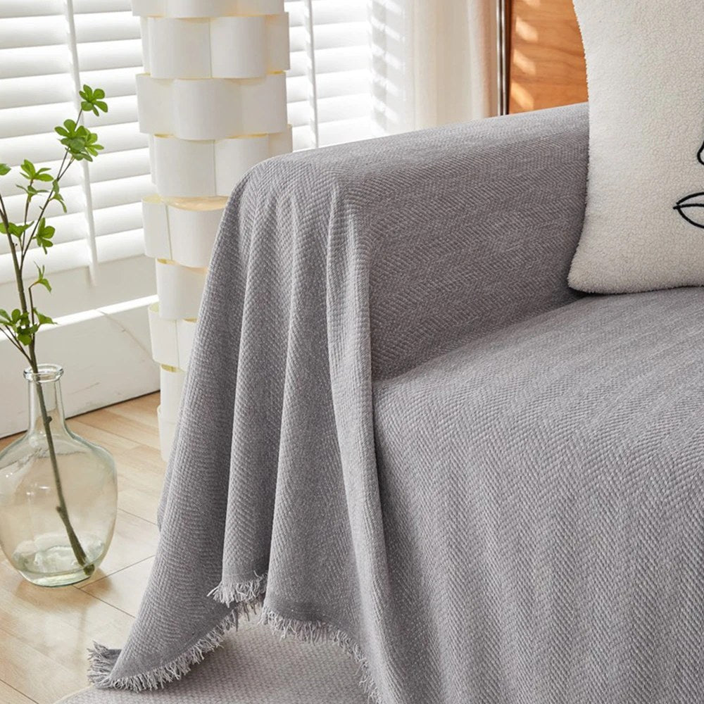 Mariefred sofa throw in Stone Grey draped over a sofa arm, product photo