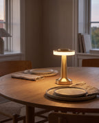 Montreux gold cordless lamp on a round oak dining table