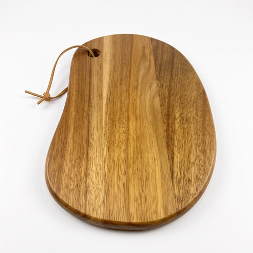 Rinteln organic acacia serving board with hanging cord on a white background