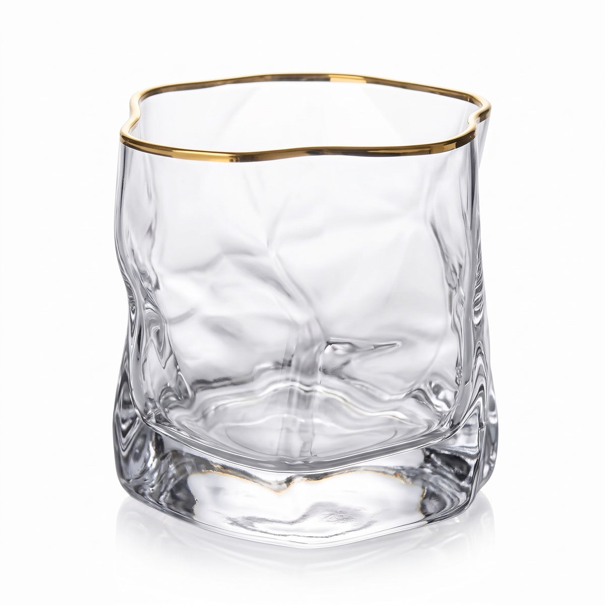 Sandhamn crumpled crystal whisky glass with gold rim on a white background