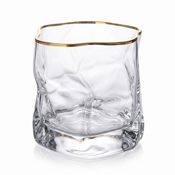 Sandhamn crumpled crystal whisky glass with gold rim on a white background