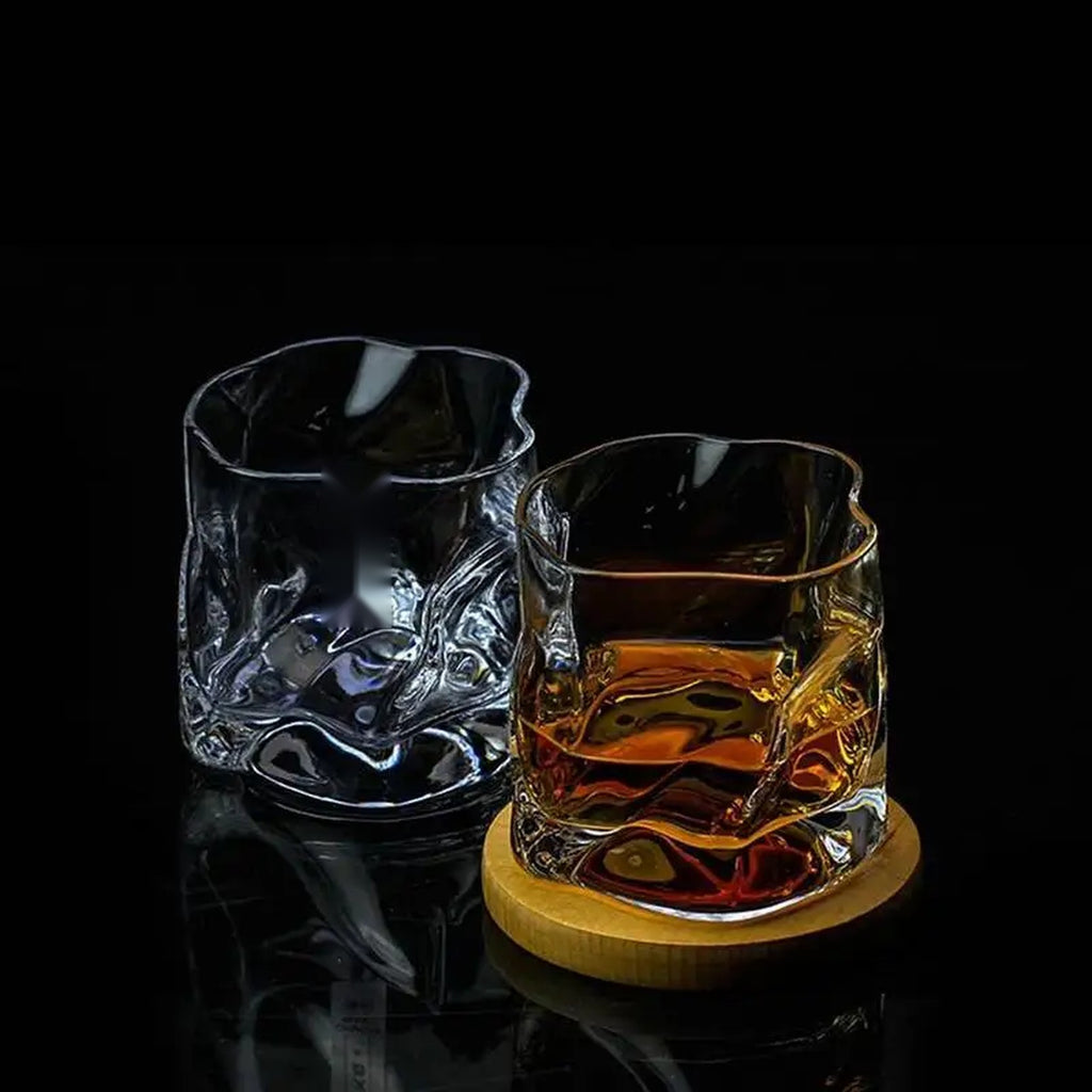 Two clear Sandhamn crystal whisky glasses, product photo on a dark background
