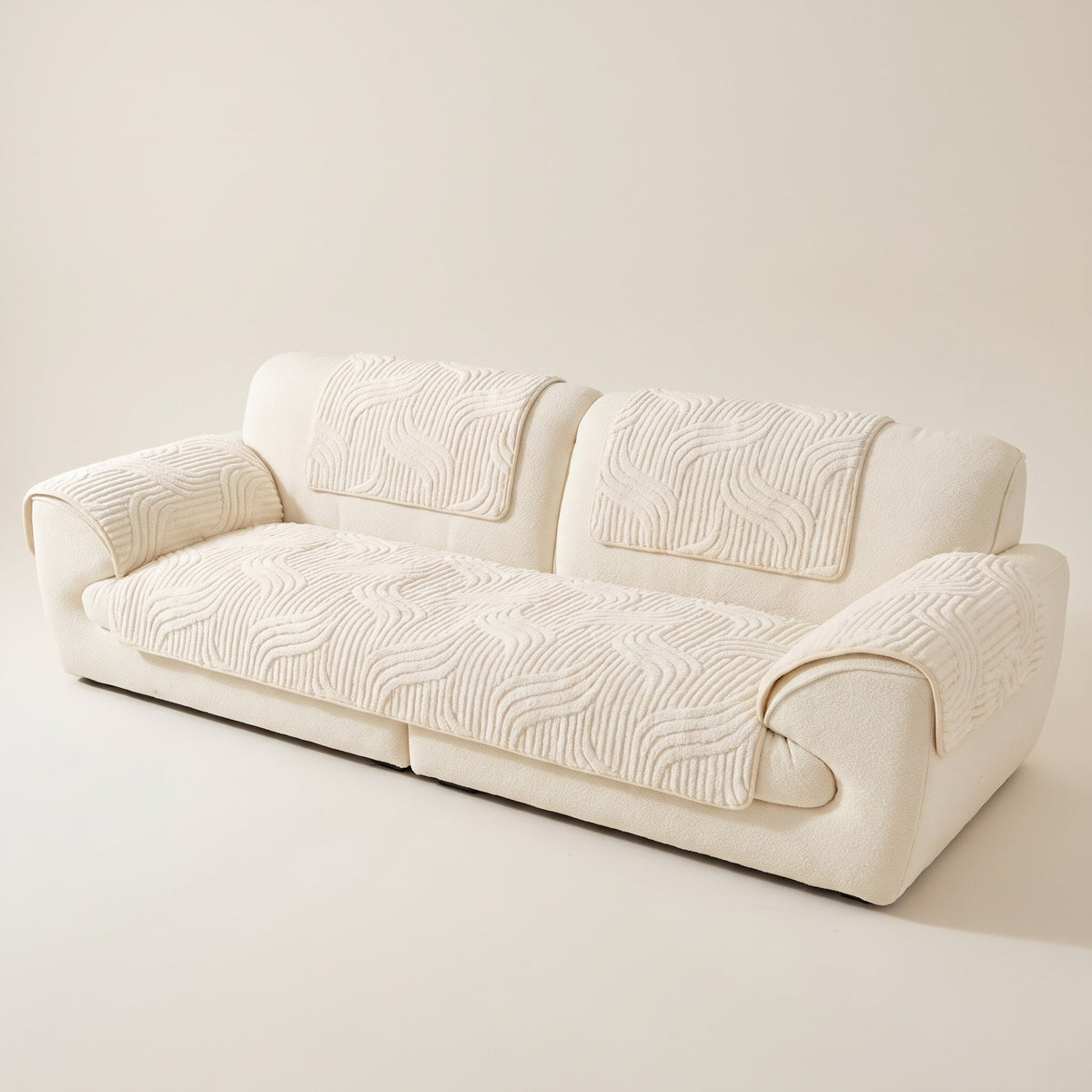 Skanderborg sculpted plush sofa pads in Cream on a cream sofa