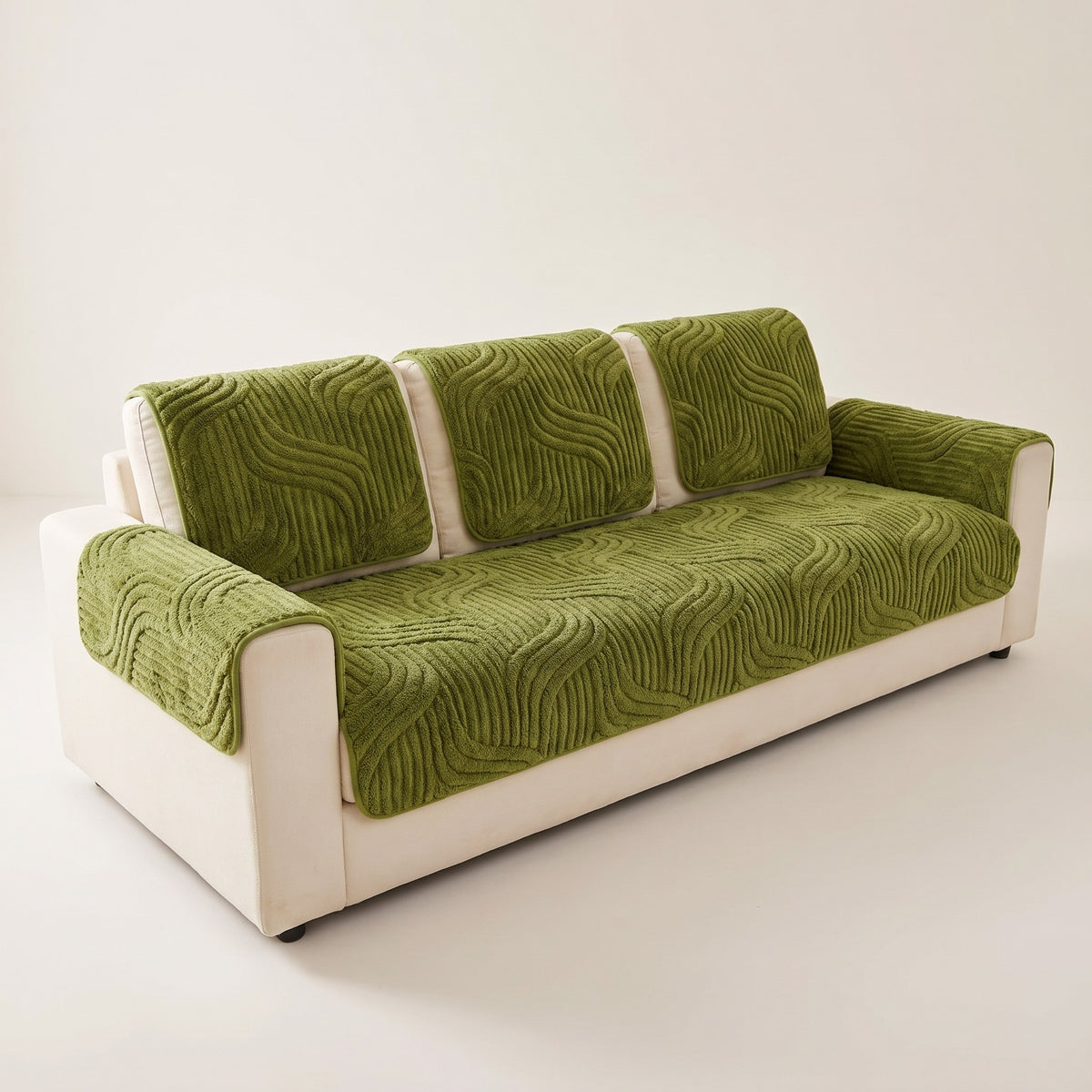 Skanderborg sculpted plush sofa pads in Olive on a cream sofa