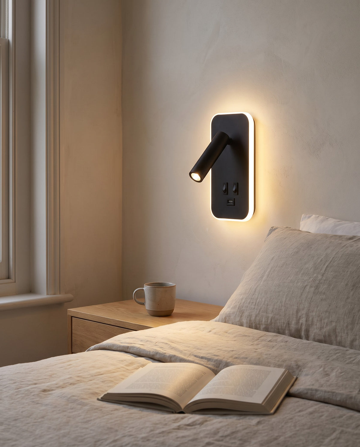 Tonning wall reading light beside a bed, the reading spot lighting an open book