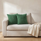 Vaasa forest green corduroy patchwork cushions on a linen sofa