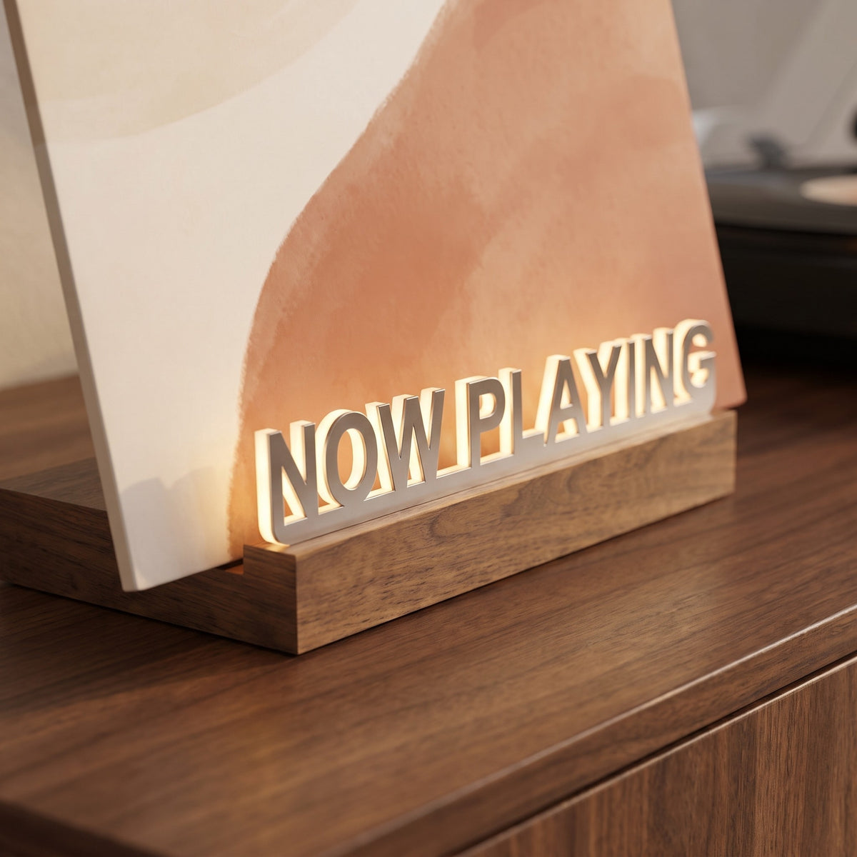 Close up of the lit Now Playing letters on the wood base
