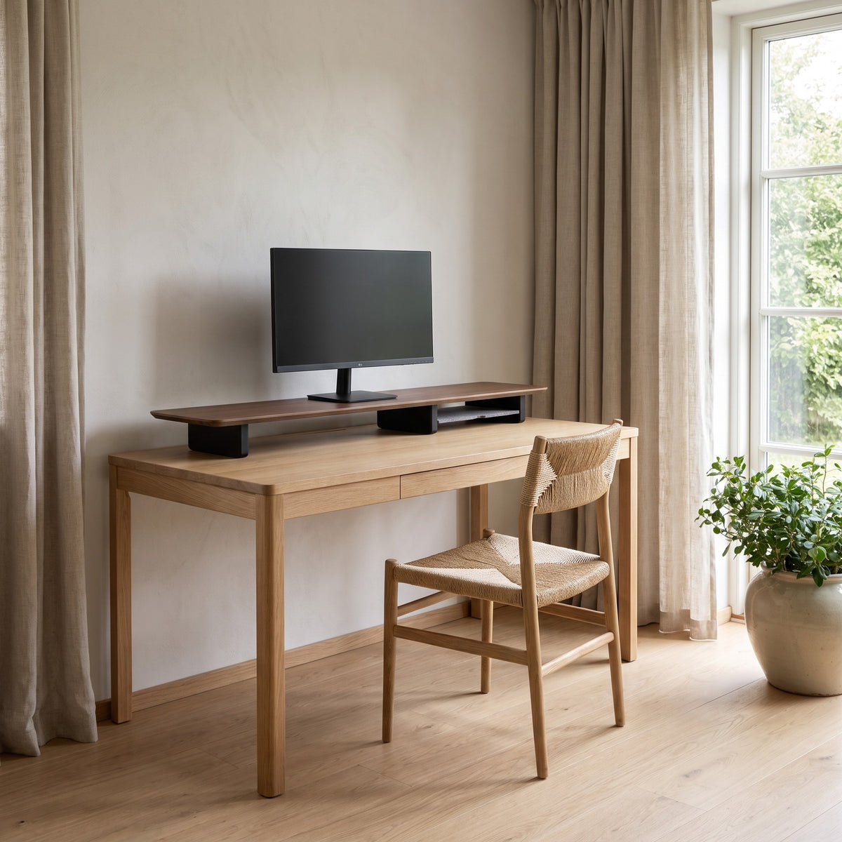 Villach walnut tone monitor stand in a calm home office