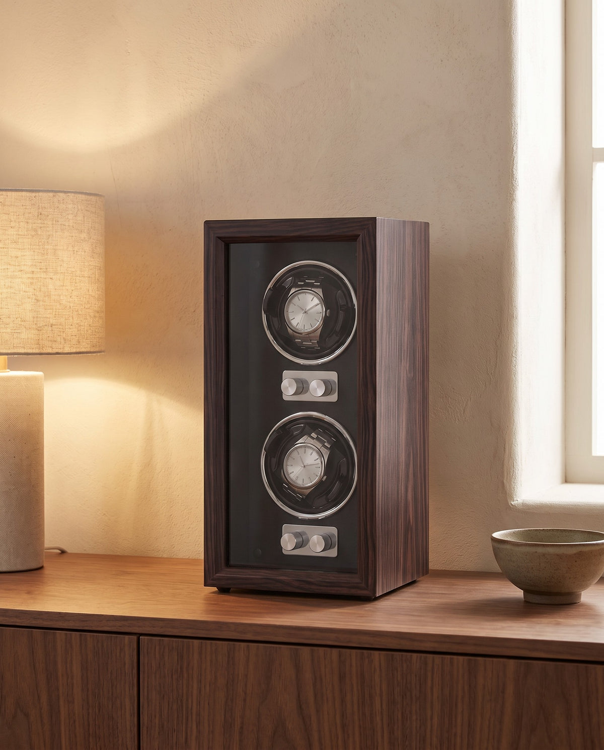 Weiden watch winder on a walnut sideboard beside a table lamp