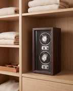 Weiden watch winder on a dressing room shelf beside folded knitwear